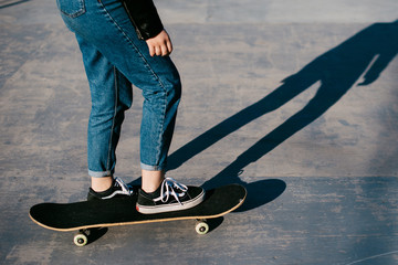 Fototapeta na wymiar A young girl riding a skateboard