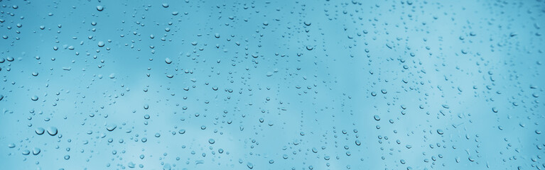 Blue glass with raindrops background texture horizontal top view isolated, rain on the window backdrop, light blue sky, clear water on space blank back, mockup nuture wall