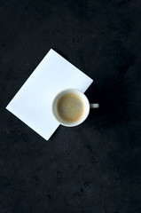 Obraz na płótnie Canvas Coffee Cup card for inscriptions wishing good morning on a black background.