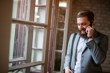 Businessman talking on mobile phone at workplace