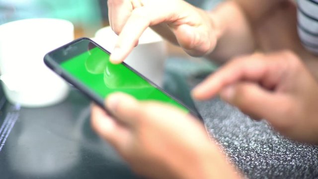 Women using multimedia smartphone outdoors, cropped