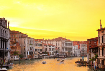 muticolored Venice houses over water of Grand canal at orange sunset, Italy, retro toned