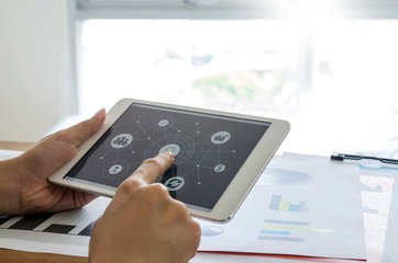Woman’s hands using tablet with business connect icons screen.