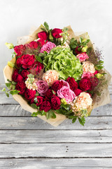 Still life with a bouquet of flowers. the florist put together a beautiful bunch of flowers. Man manual work used different types of flowers and colors. copy space
