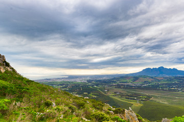 Fototapeta na wymiar Aerial view of Cape Town from Sir Lowry's Pass, South Africa. Winter season, cloudy and dramatic sky.