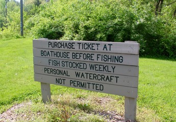 The wooden park sign on a close view.