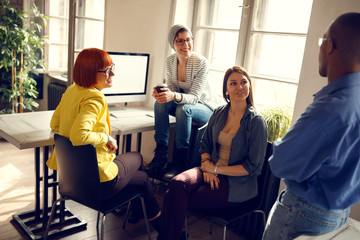 Female workers with manager in office