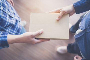 Man handed the Box Paper to each other paper. Box.Cardboard boxes, vintage effect filter style pictures