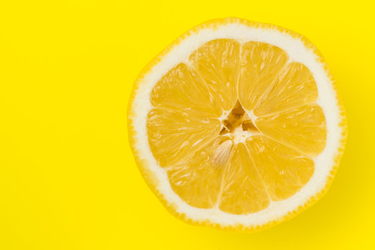 Top view of lemon on yellow back ground