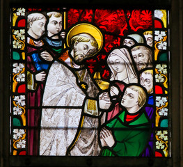 Stained Glass - Priest giving Holy Communion