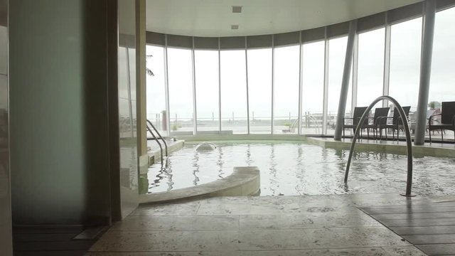 POV shot approaching indoor pool at luxury hotel