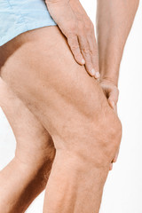Athlete man massaging a painful  quadriceps and the knee after a sport accident. It could be a...