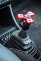 Close-up Spinner-Fidget is a toy for shunting time being in the car in standing in an automotive...