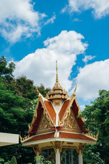 Fototapeta premium Thai pagoda with green tree and clear blue sky