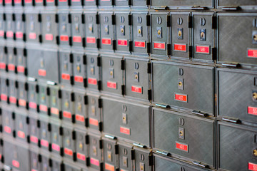 Rows of many locked post office boxes with red number labels