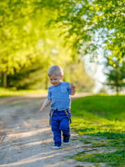 Toddler child outdoors. Rural scene with one year old baby boy