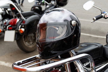 Black moto helmet motorcycle and motorbikes on blurred background