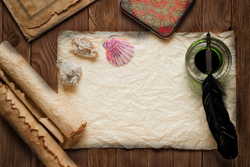 White goose feather and inkwell, scroll on the background table