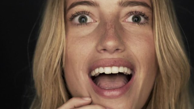 Slow motion shot of woman thinking and then looking up in surprised joy