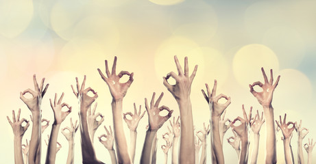 Group of people rise hands