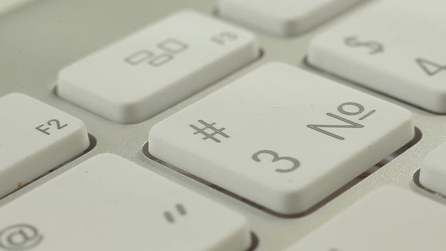 Macro video of keyboard buttons with numbers and functions. Press the button.