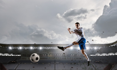 Fototapeta na wymiar Soccer player at sport arena