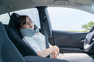 young female driver sleeping in vehicle.