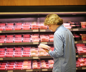 Man purchasing a packet of meat at the supermarket 
