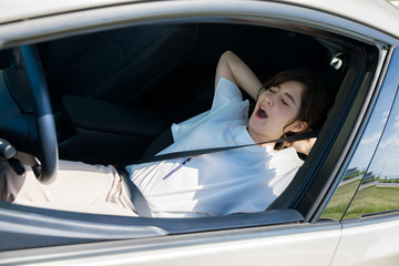 young female driver sleeping in vehicle.