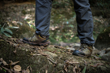 Close up of man feet while hiking in nature.