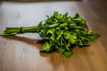Spice green parsley lies on a wooden table