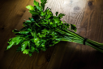 Spice green parsley lies on a wooden table