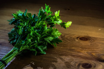 Spice green parsley lies on a wooden table
