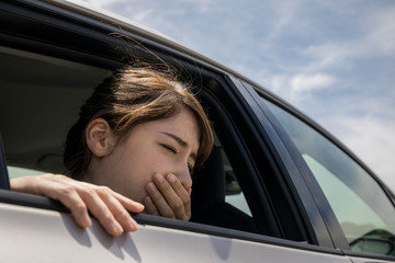 young woman getting carsickness.