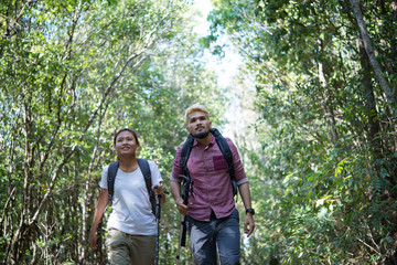 Naklejka na ściany i meble Couple go adventure hiking in mountain asia forest.