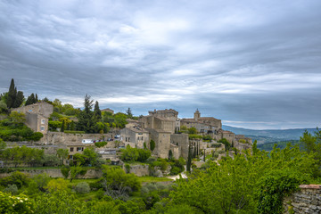 Fototapeta na wymiar View on the beautiful medieval village of Gordes in the cloudy day. This village is included in list of 