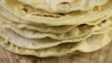 Fresh white corn tortillas on cutting board