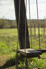Empty wooden swing in the countryside
