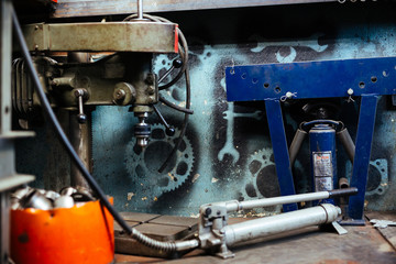 Background image of various equipment on floor in mechanics workshop