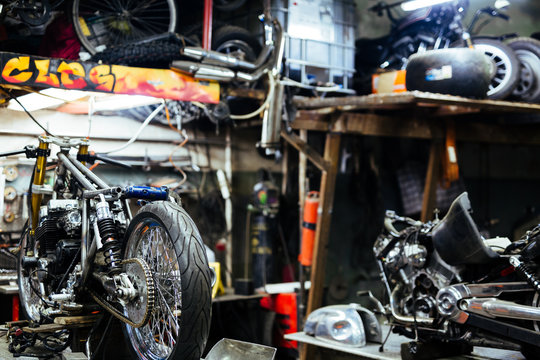 Background image  of disassembled motorcycle ready for repairing in mechanics garage