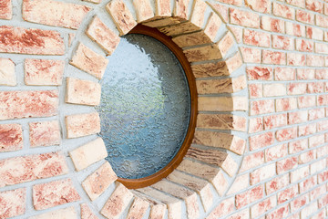 Obraz na płótnie Canvas Round window on brick wall - shallow depth of field - focus on the closer arch of the window