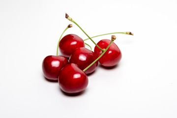 Obraz na płótnie Canvas Five juicy red cherries
