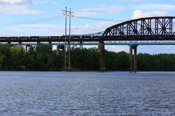 Railroad and car bridges over Hudson River at Schodack State Park. Freight train passing through.