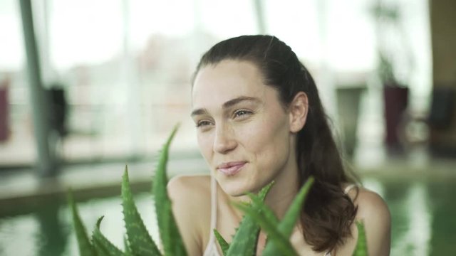 Young woman smling cheerfully in health spa, portrait