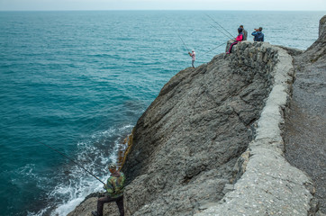 Fototapeta premium Fishermen on the rocks