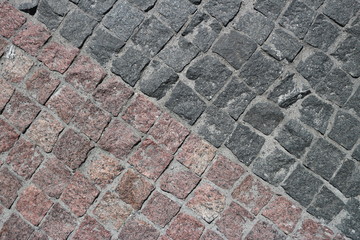 Rubble gray and brown square stones paved road