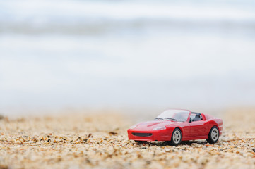 Fototapeta na wymiar red toy car on beach