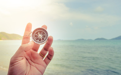 Compass in hand with vintage bachground