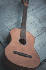 Fototapeta na wymiar Brown antique guitar on a blue wooden door background