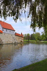 Naklejka na ściany i meble Weißenburg city. Bavaria. Germany. Part of the fortress wall and moat with water